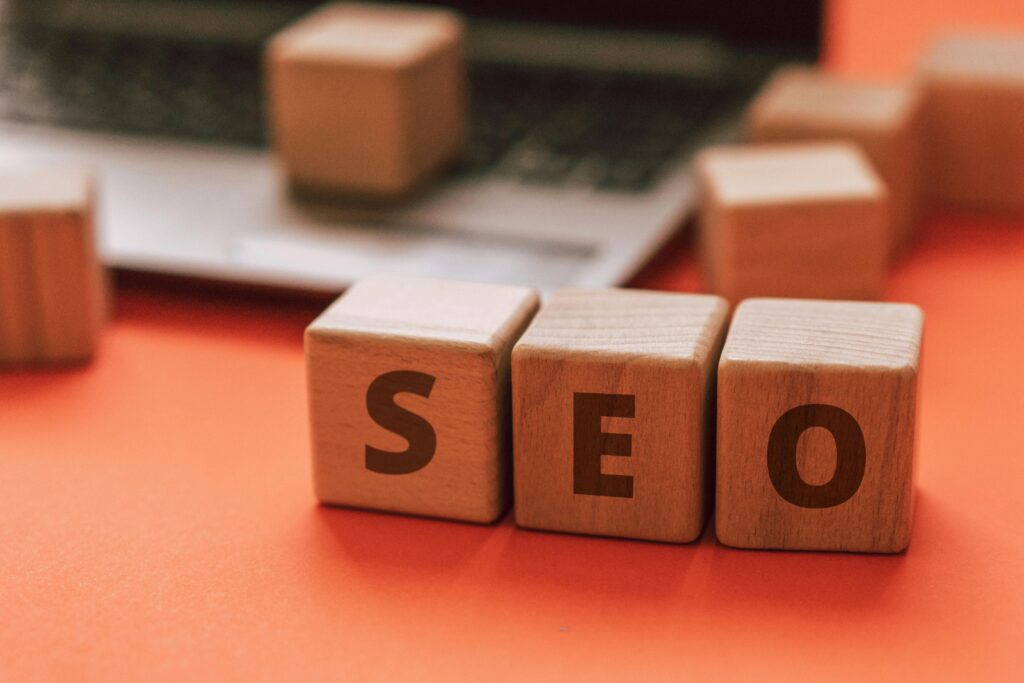 pexels photo 9822732 9822732 1 Wooden blocks spelling SEO on a laptop keyboard convey digital marketing concepts.