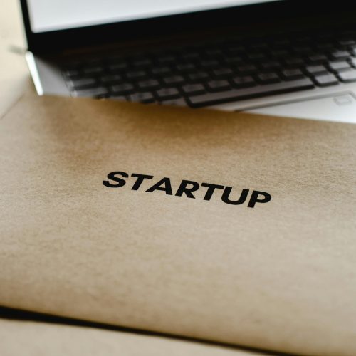 Close-up of a startup folder and laptop, representing business and technology innovation.